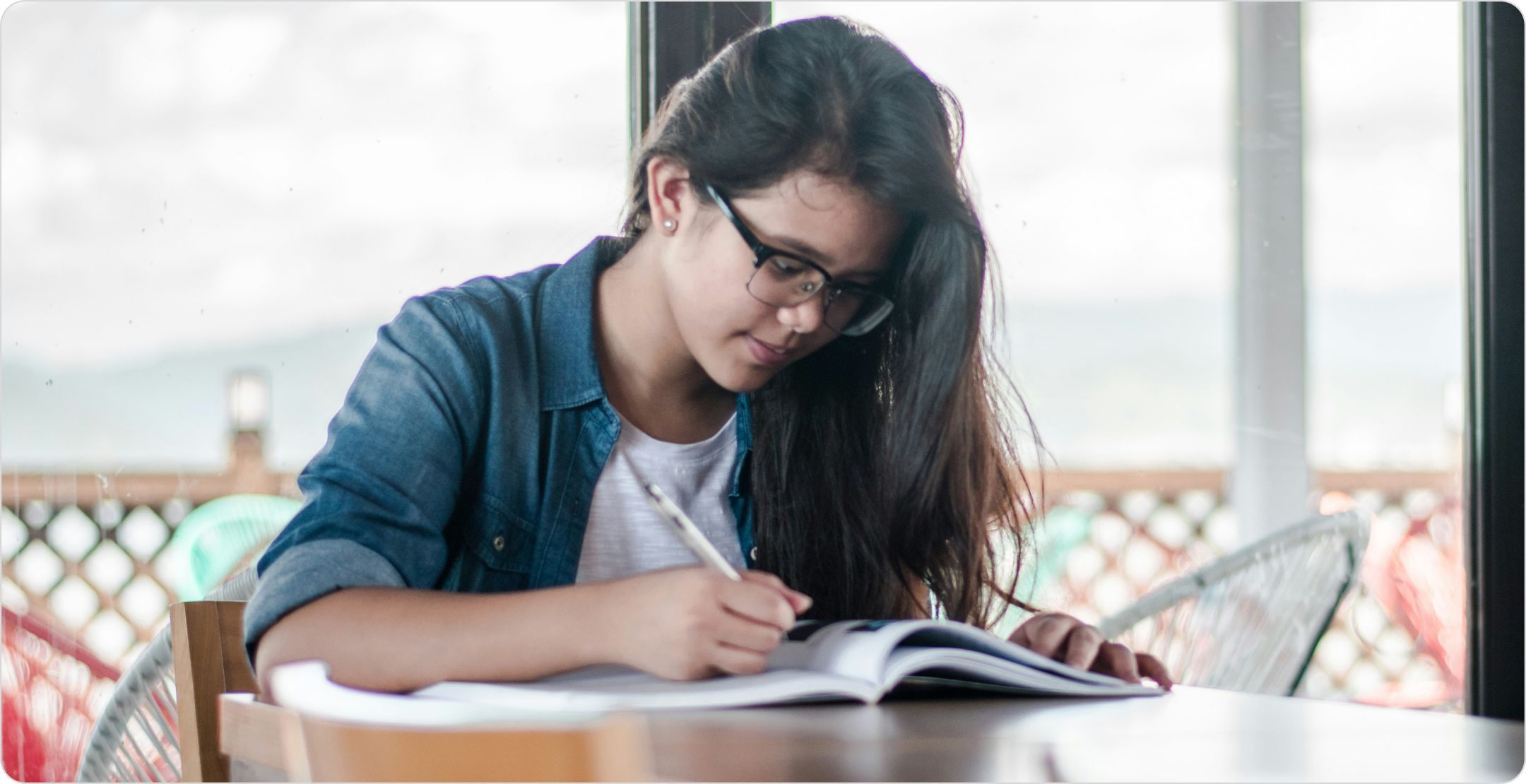 Woman student at a desk studying; representing learning Conjoint Analysis Basics