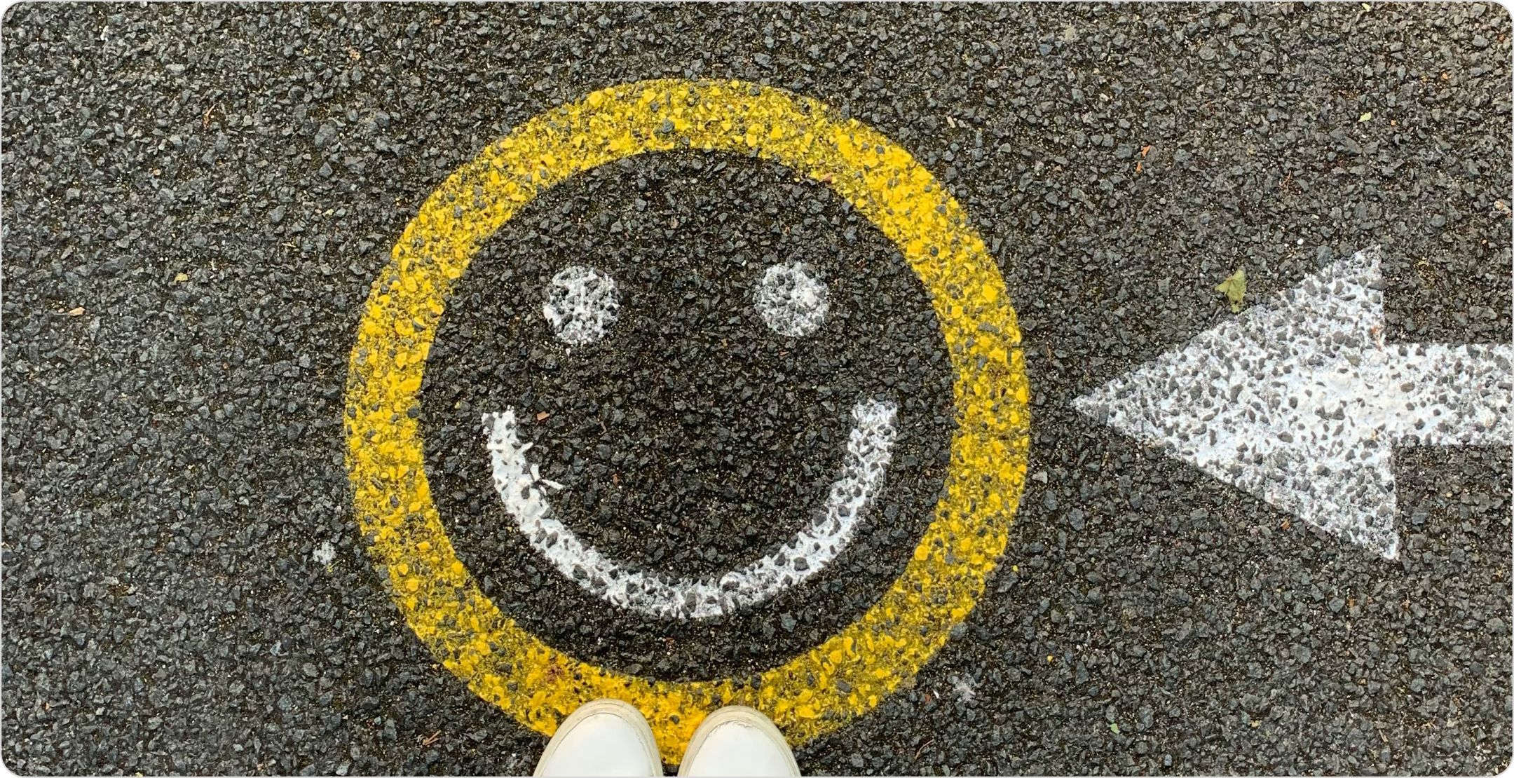 Smiley face painted on asphalt: representing customer satisfaction surveys