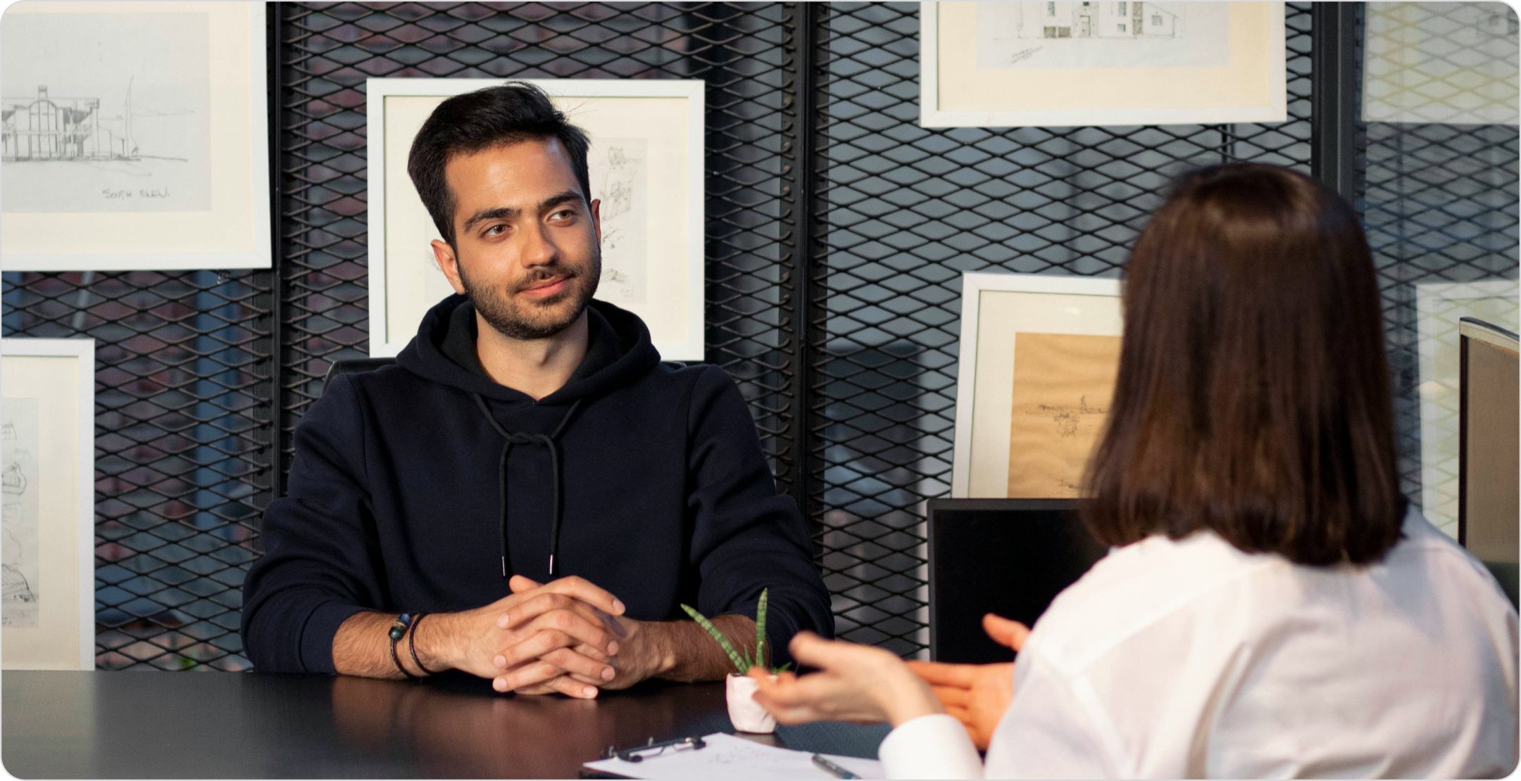 A man and a woman in an interview. Representing primary research.