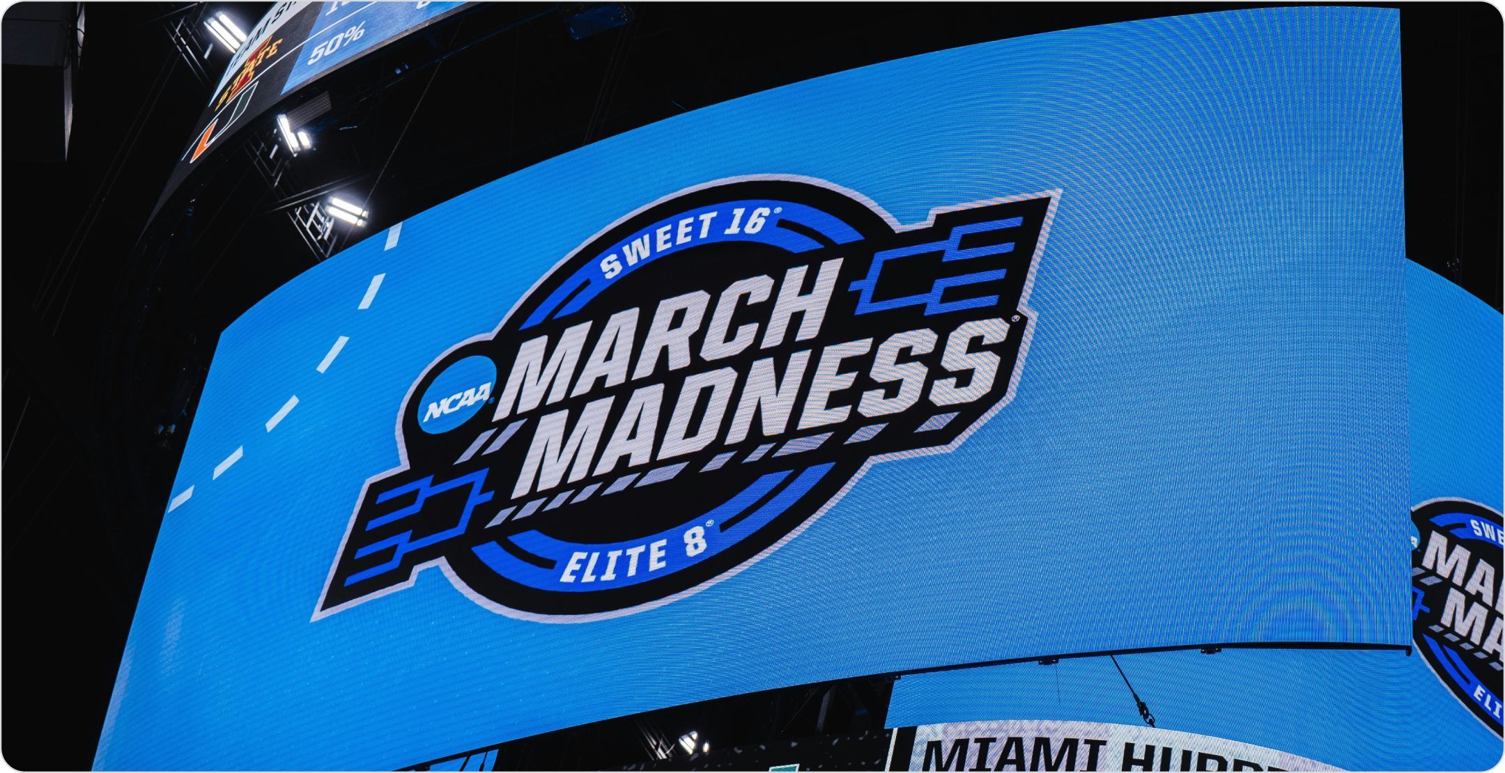 The March Madness logo on a giant arena display. 