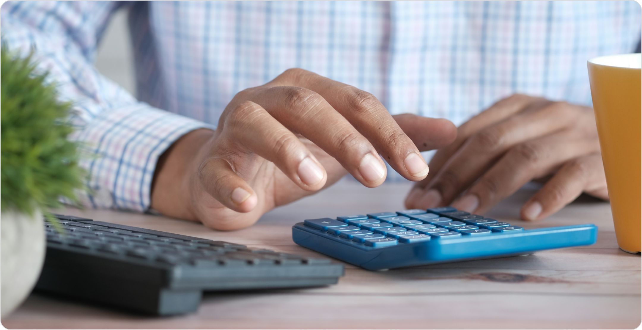 Man using a calculator on a desk. Representing quantitative data.