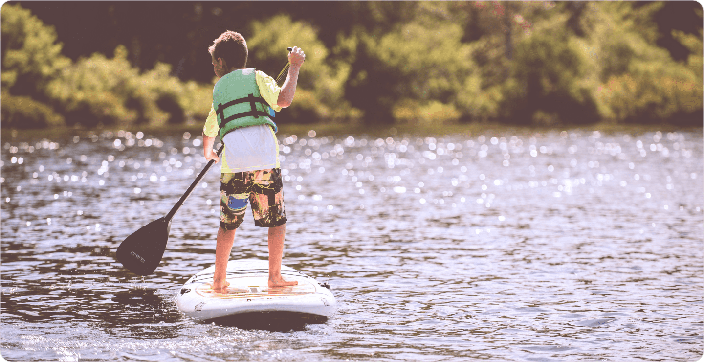 Kid paddling on a paddleboard like one that Lifetime would have optimized using conjoint analysis